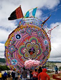 Group of people in traditional windmill against sky