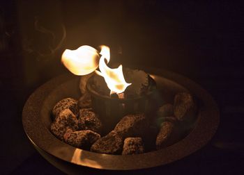 High angle view of lit candles on table