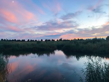 Scenic view of lake against sky during sunset