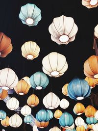 Low angle view of illuminated lanterns hanging against ceiling