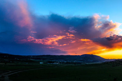 Scenic view of dramatic sky over landscape