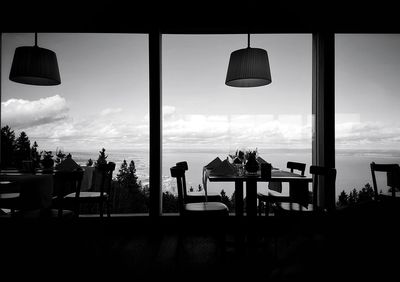 Chairs on sea against sky