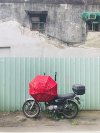 Bicycle parked against wall of building