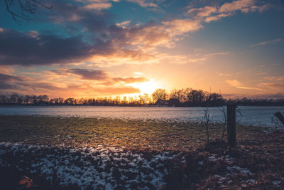 Scenic view of lake against sky during sunset