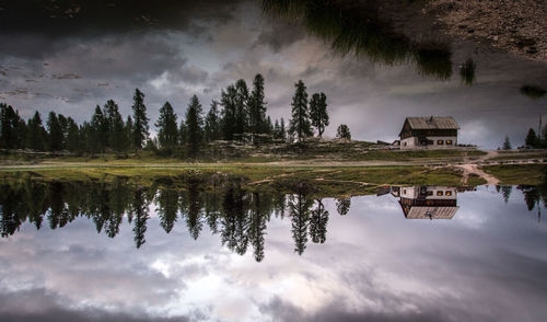 Scenic view of calm lake against cloudy sky