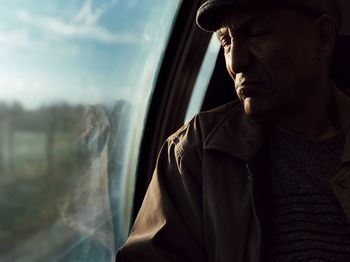 Close-up of man against window