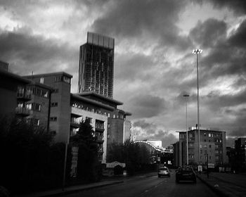 View of buildings in city against cloudy sky