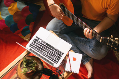 High angle view of man playing guitar