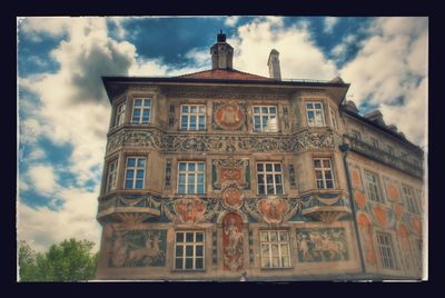 Low angle view of building against cloudy sky