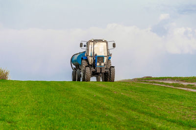 Tractor on field against sky