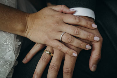 Midsection of couple holding hands