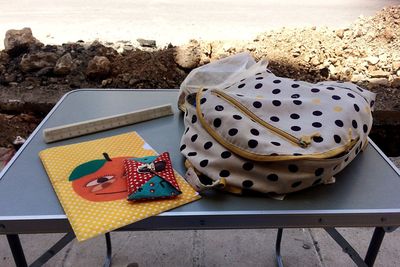 High angle view of backpack with folder on table