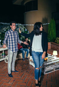 Young friends during party in backyard at night