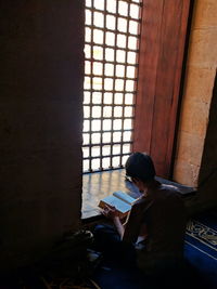 Man reading book indoors