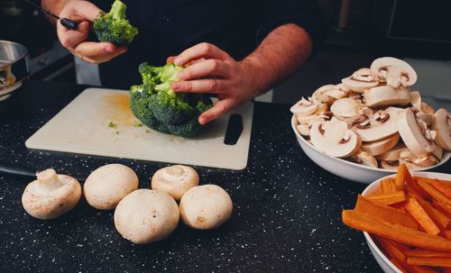 Close-up of man preparing food on cutting board