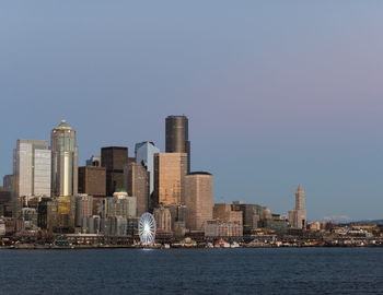 City at waterfront against sky