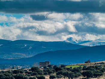 Panoramic view of buildings and mountains against sky