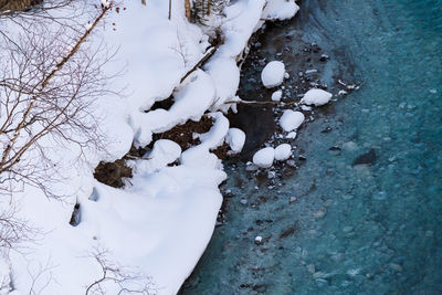 High angle view of snow covered trees on field
