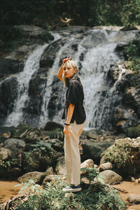 Full length of woman standing on rock