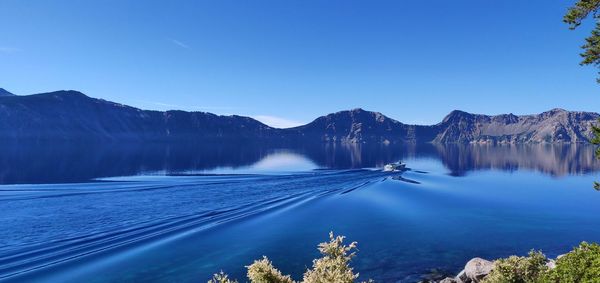 Scenic view of mountains against blue sky