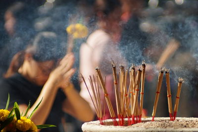 Close-up of lit candles in temple