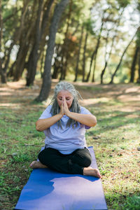 Portrait of young woman sitting on field