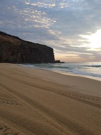 Scenic view of beach against sky during sunset