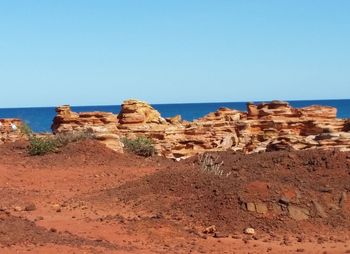 Scenic view of desert against clear blue sky