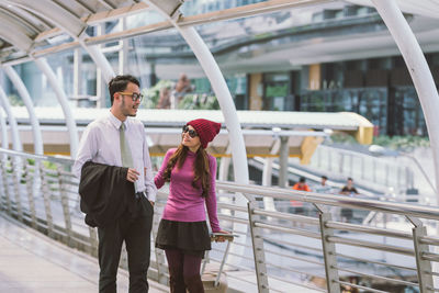 Full length of men standing on railing