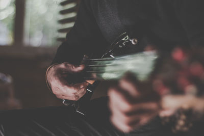 Midsection of person playing guitar