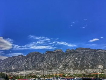 Scenic view of mountains against blue sky