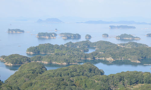 Scenic view of lake by trees against sky