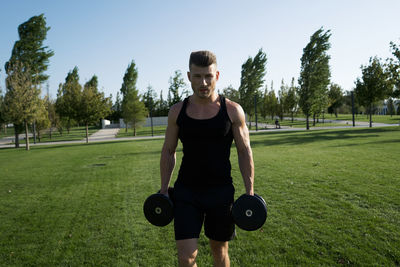 Portrait of young man exercising in gym