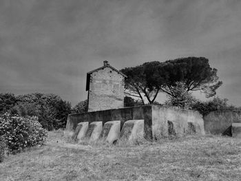 Built structure on field against sky
