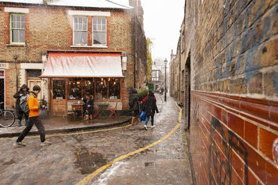 Rear view of people walking on street