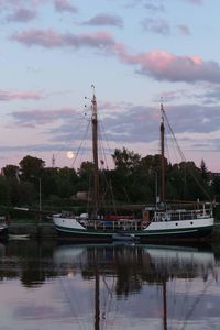 Boats moored at harbor