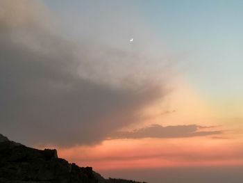 Low angle view of silhouette mountain against sky at sunset