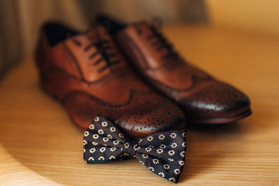 Close-up of shoes on hardwood floor