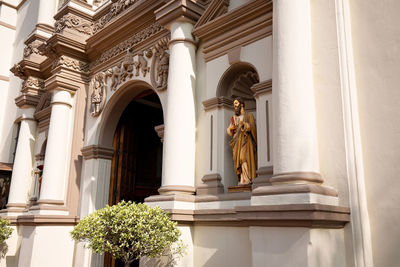 Low angle view of statue against historic building