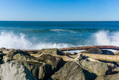 Waves roll onto the rock breakwater in westport, washington.