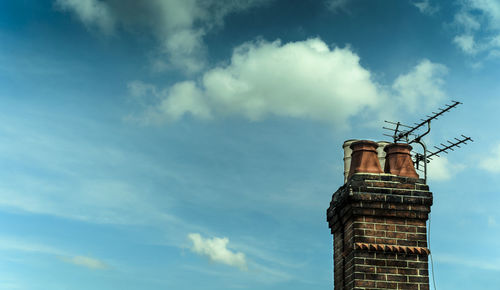 Low angle view of chimney against blue sky