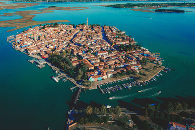 High angle view of townscape and sea in city