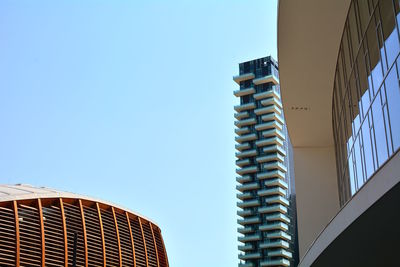 Low angle view of modern building against clear blue sky