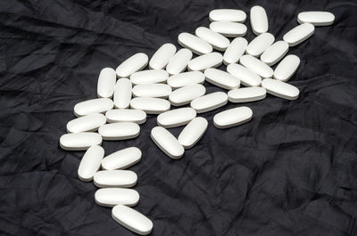 White sports vitamins pills on black background