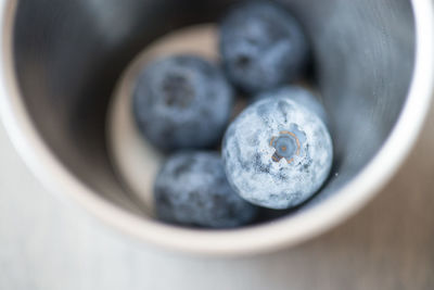 High angle view of blueberries in container on table