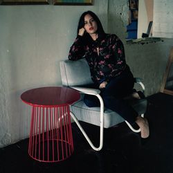 Portrait of young woman sitting on chair