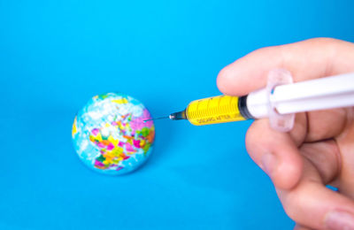 Close-up of hand holding blue background