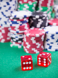 High angle view of gambling chips and dices on casino table