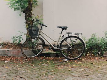 Bicycle parked against wall