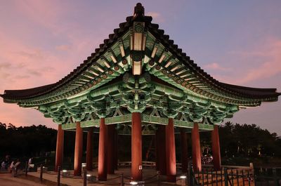 Traditional building against sky at dusk